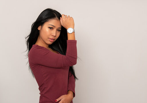 Beautiful young asian woman with long black hair wearing wrist watch