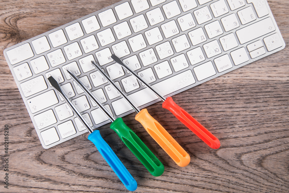 Poster screwdriver on the computer keyboard
