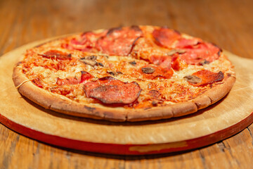 Textured surface of cheese pizza with spices. Homemade fresh baking recipe