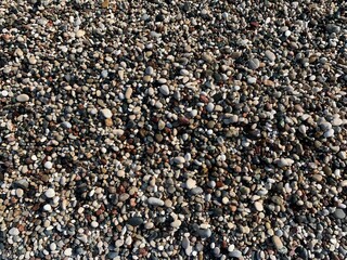 Small wet sea pebbles background