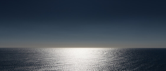 abstract panorama view of ocean water with glistening sunlight and orange and blue sky