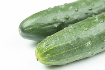 Whole fresh cucumbers isolated above white background