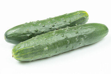 Whole fresh cucumbers isolated above white background