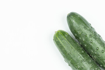 Whole fresh cucumbers isolated above white background