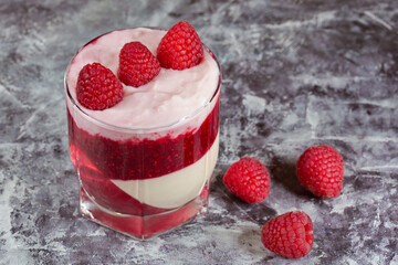 White delicious yogurt dessert with raspberry berries, jam and raspberry jelly. Healthy Breakfast, light snack. The concept of healthy eating.