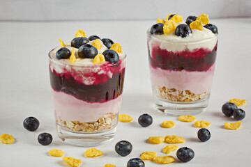 White delicious yogurt dessert with blueberries, granola, cornflakes and jelly. Healthy Breakfast, light snack. Horizontal.