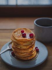oatmeal pancakes on a plate with honey and berries, breakfast