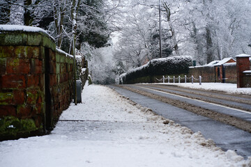 empty snow covered road through a rural village
