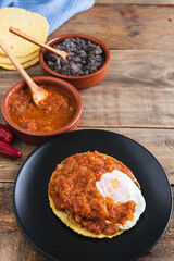 Huevos rancheros Mexican breakfast on a wooden base. Mexican cuisine. Copy space.