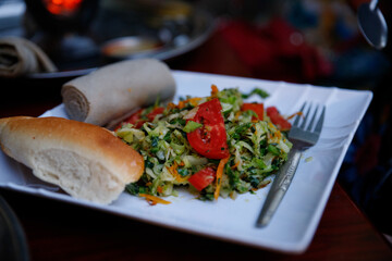 Ethiopian traditional dish, sour pancake with hot pepper sauce and other vegetables