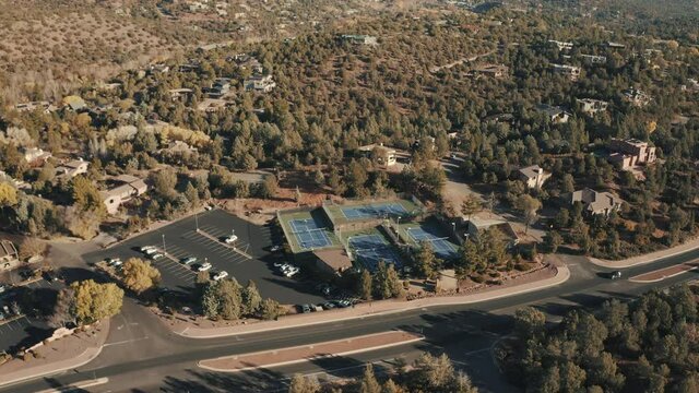 Aerial Drone View of residential areas and roads in Sedona and Oak Creek Canyon in Arizona on a bright and sunny fall day showing unique red rock formations and landscapes 