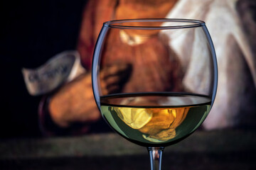 The classic portrait of the old woman by Italian artist Giorgione (1477-1510) shown as an inverted reflection in a wine goblet.