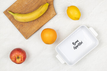 Fresh fruits on the table with Buon Appetito sign in the bowl