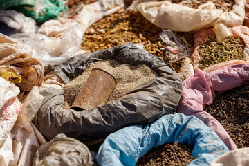 bags of colored spices and other herbs in the ethiopian market standing in the hot sun