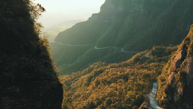 Amazing road inside a tropical rainforest mountain at sunrise aerial view, Serra Do Corvo Branco, Gr&atilde;o Par&aacute;, Santa Catarina, Brazil