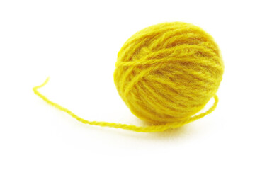 Yellow ball of knitting thread on a white background