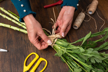 Hands of a woman arranging a bouquet of flowers