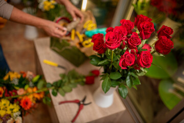Hands of a woman arranging a bouquet of flowers