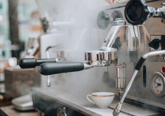 Coffee flowing into a cup from espresso machine