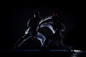 Foto op Aluminium Karate martial arts fighter in white kimono in the gym © qunica.com