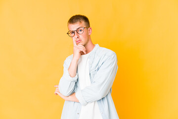 Young caucasian handsome man unhappy looking in camera with sarcastic expression.