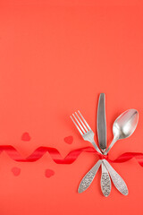 Festive table setting for Valentine's day on the red surface