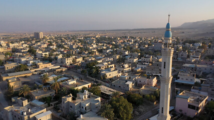 Fototapeta premium Mosque Tower minaret in Jericho city with Birds- aerial view Drone view of Jericho city,sunset, Jordan Valley, Israel/palestine 