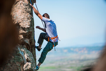 Rock climber battles his way up