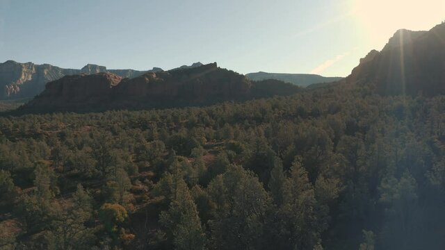 Aerial Drone View of residential areas and roads in Sedona and Oak Creek Canyon in Arizona on a bright and sunny fall day showing unique red rock formations and landscapes 