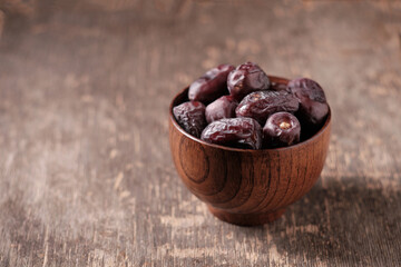 Cup with dates on a dark background, side view, close up
