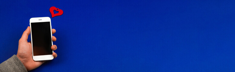 Man holds smartphone with one love message, concept Valentine's day, social media banner on blue isolated background