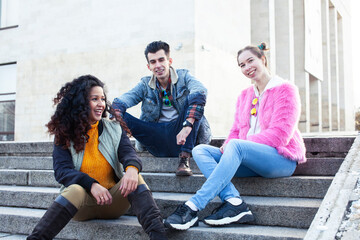 Obraz premium cute group of teenages at the building of university with books huggings, diversity nations real students lifestyle