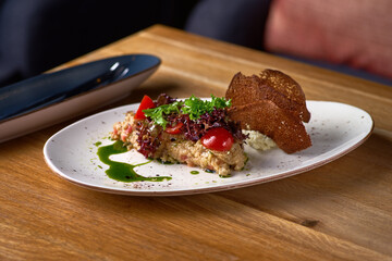 Eggplant caviar with cheese mousse on the table, serving in a restaurant, menu food concept. copy space.