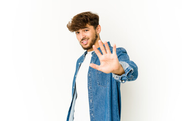 Young arab man on white background rejecting someone showing a gesture of disgust.
