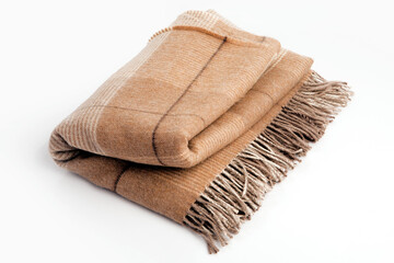 Warm brown alpaca wool or cashmere blanket isolated on white background. Beige, brown squared wool...