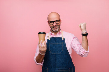 Bald mature man euphoric with happiness with coffee in recyclable cardboard cup