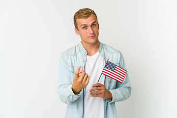 Young caucasian man holding a american flag isolated on white background