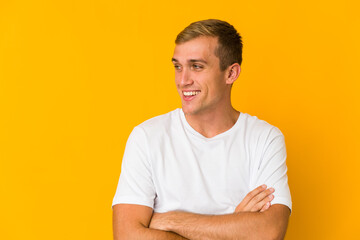 Young caucasian handsome man smiling confident with crossed arms.