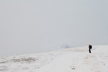 Winter adventure in mountains. Lonely traveller trying to fing path using  GPS maps. Winter in...