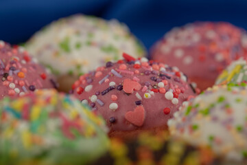 Colorful sweet chocolate small doughnuts with sprinkles