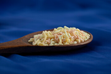 A wooden spoon full of colorful sprinkles