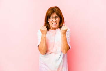 Senior caucasian woman isolated showing fist to camera, aggressive facial expression.