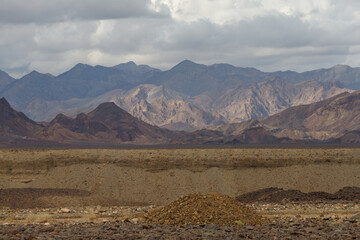 the Ethiopian desert where the earth is brown and the sky is dramatically dark moaning in contrast