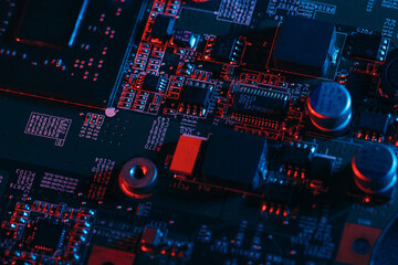 Hardware technology concept in neon light. Motherboard in blue-red light. Computer  component. Dark photo.Neon Colors.GPU processor. CPU