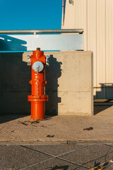 Fototapeta na wymiar Red fire hydrant on the street