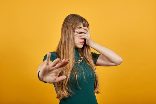 Palm arm raised air angry look straight you will not pass through facial expression harsh. Serious looking strict demands stop, pulls hand forward camera, says no, disagrees, frowns face, warning