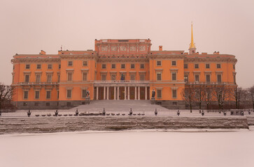 Snow-covered Moika river and a view of the Mikhailovsky Palace in St. Petersburg, a snowy and traditionally gloomy day in December. Winter in St. Petersburg in Russia