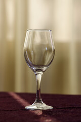 a glass of wine stands empty on the table