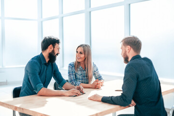 managers discussing the results of an interview with a young employee
