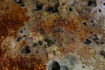 colored stones in a volcanic crater falling from the heat
